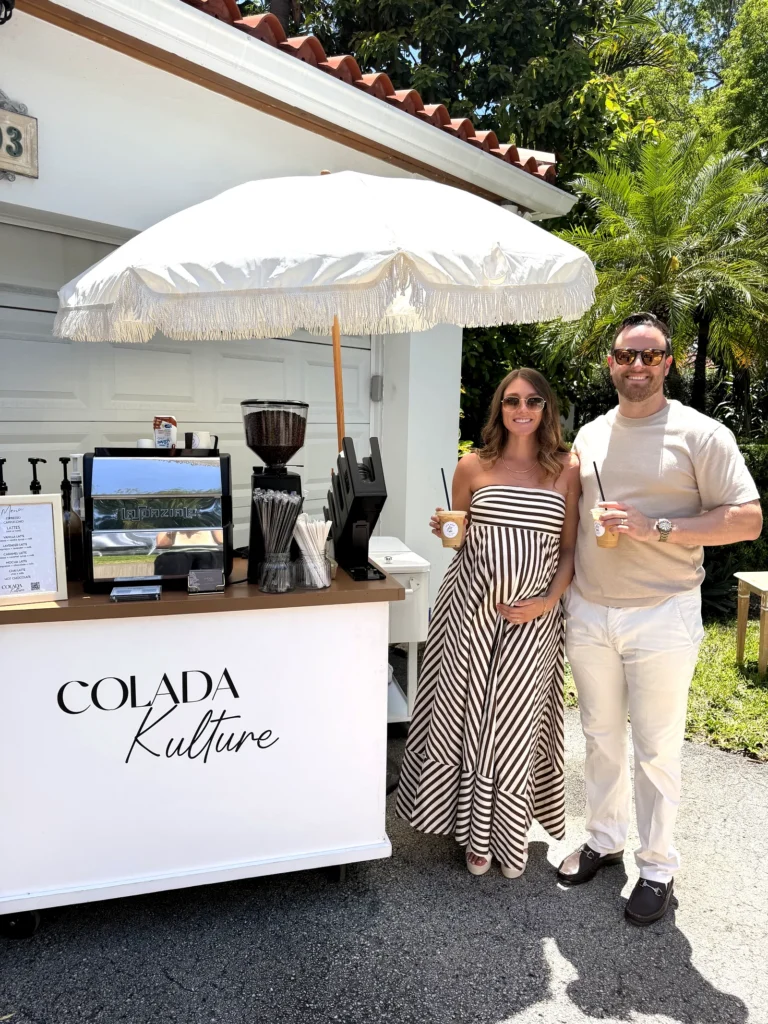 Guests enjoying iced lattes from the Colada Kulture coffee cart at a private residence in Coral Gables